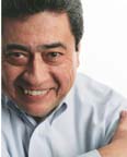 man wearing a button down shirt,  with a smile